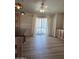 Bright dining area featuring beautiful wood floors, pendant lighting, and a sliding door providing access to the outside at 2233 E Behrend Dr # 203, Phoenix, AZ 85024