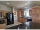 Bright kitchen featuring wood cabinets, black appliances, and granite countertops at 2233 E Behrend Dr # 203, Phoenix, AZ 85024