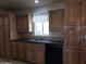 Kitchen area featuring a stainless steel sink and wood cabinetry at 2233 E Behrend Dr # 203, Phoenix, AZ 85024