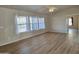 Spacious living room with wood-look floors and natural light from the windows at 2233 E Behrend Dr # 203, Phoenix, AZ 85024