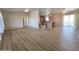 Open-concept living space with wood-look floors and access to kitchen and balcony at 2233 E Behrend Dr # 203, Phoenix, AZ 85024