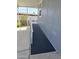 Home exterior featuring an accessible ramp with covered parking and colorful flowers at 2233 E Behrend Dr # 203, Phoenix, AZ 85024