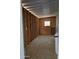 Unfinished storage or utility area with visible framing and a water softener in the corner at 2233 E Behrend Dr # 203, Phoenix, AZ 85024