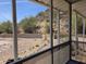 An outdoor screened in porch overlooking the desert landscape with view of mountains at 2233 E Behrend Dr # 203, Phoenix, AZ 85024