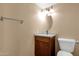 Neutral bathroom with wood vanity and brushed nickel hardware, toilet, mirror, and lighting at 2338 W Lindner Ave # 52, Mesa, AZ 85202