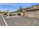 Charming home exterior featuring a private garage, an enclosed walk-through gate, and desert landscaping at 2338 W Lindner Ave # 52, Mesa, AZ 85202