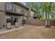 Back of a home with a patio, gravel, and mature trees at 2338 W Lindner Ave # 52, Mesa, AZ 85202