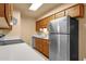 Well-lit kitchen featuring stainless steel appliances and modern countertop at 2338 W Lindner Ave # 52, Mesa, AZ 85202