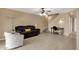 Spacious and open living room featuring a staircase, ceiling fan, and ceramic tile flooring at 2338 W Lindner Ave # 52, Mesa, AZ 85202