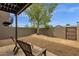Back patio with two chairs and mature tree for shade at 2338 W Lindner Ave # 52, Mesa, AZ 85202