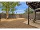 The patio is enclosed with a gravel surface and a lush tree at 2338 W Lindner Ave # 52, Mesa, AZ 85202