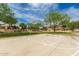 Community basketball court surrounded by trees, offering recreational opportunities for residents at 27007 N 20Th Ln, Phoenix, AZ 85085
