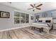 Well-lit bedroom features light-colored walls, wood-look floors, and ample natural light from the window at 27007 N 20Th Ln, Phoenix, AZ 85085