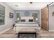 Cozy bedroom with a queen-sized bed, wood-look floors, and a sliding barn door feature at 27007 N 20Th Ln, Phoenix, AZ 85085