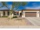 Charming single-story home featuring manicured landscaping, a brick-paved walkway, and an attached garage at 27007 N 20Th Ln, Phoenix, AZ 85085
