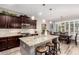 Spacious kitchen featuring dark wood cabinetry, granite countertops, and stainless steel appliances at 27007 N 20Th Ln, Phoenix, AZ 85085