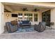 Cozy covered patio with comfortable seating, ceiling fans, and a TV, creating an ideal outdoor living space at 27007 N 20Th Ln, Phoenix, AZ 85085
