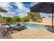 Inviting backyard pool area with a relaxing chaise lounge and lush landscaping for serene outdoor living at 27007 N 20Th Ln, Phoenix, AZ 85085