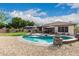 Backyard oasis features a stunning pool, lush landscaping, and comfortable lounge seating under the sun at 27007 N 20Th Ln, Phoenix, AZ 85085