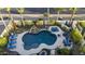 Aerial view of a backyard oasis featuring a pool, hot tub, fire pit, and lush landscaping at 2991 E Fandango Dr, Gilbert, AZ 85298