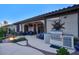 Expansive covered back patio with an outdoor kitchen, grill, and comfortable seating, ideal for relaxation at 2991 E Fandango Dr, Gilbert, AZ 85298