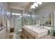 Bright bathroom featuring a large mirror, granite countertop, and glass-enclosed shower, offering a spa-like experience at 2991 E Fandango Dr, Gilbert, AZ 85298