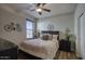 Well-lit bedroom with a ceiling fan, comfortable bed, and stylish decor for a relaxing ambiance at 2991 E Fandango Dr, Gilbert, AZ 85298