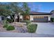 Inviting home exterior showcasing desert landscaping and a dark brown two-car garage at 2991 E Fandango Dr, Gilbert, AZ 85298