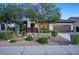 Inviting home exterior showcasing desert landscaping, a decorative front door, and a two-car garage at 2991 E Fandango Dr, Gilbert, AZ 85298