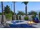 Luxurious hot tub surrounded by mature landscaping, rocks, and a cozy fire pit, creating a private oasis at 2991 E Fandango Dr, Gilbert, AZ 85298