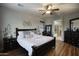 Serene main bedroom with hardwood floors, a ceiling fan, and an ensuite bathroom at 2991 E Fandango Dr, Gilbert, AZ 85298