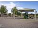 Community playground featuring play structure, swings, and sunshade for Gathering fun at 2991 E Fandango Dr, Gilbert, AZ 85298