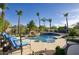 Inviting backyard pool with rock waterfall, comfortable lounge chairs, and lush landscaping perfect for relaxation at 2991 E Fandango Dr, Gilbert, AZ 85298