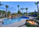 Backyard pool and spa featuring a rock waterfall, fire bowls, and a beautifully landscaped outdoor setting at 2991 E Fandango Dr, Gilbert, AZ 85298