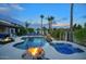 Backyard pool and spa area with a rock waterfall, fire bowls, and comfortable patio seating at 2991 E Fandango Dr, Gilbert, AZ 85298
