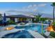 Backyard pool and spa featuring a rock waterfall, fire bowls, and ample patio seating for outdoor entertaining at 2991 E Fandango Dr, Gilbert, AZ 85298