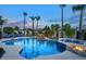 Backyard pool and spa area with a rock waterfall, fire bowls, and lush tropical landscaping at 2991 E Fandango Dr, Gilbert, AZ 85298