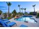 Backyard pool and spa area with a rock waterfall, fire bowls, and comfortable lounge chairs for outdoor relaxation at 2991 E Fandango Dr, Gilbert, AZ 85298