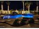 Backyard pool and waterfall features with palm tree lighting creating an enchanting scene at 2991 E Fandango Dr, Gilbert, AZ 85298