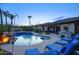 Backyard pool and spa with a rock waterfall, fire bowls, and comfortable lounge chairs for outdoor entertaining at 2991 E Fandango Dr, Gilbert, AZ 85298