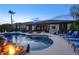 Stunning backyard pool with rock features, lush landscaping, and an outdoor kitchen perfect for entertaining at 2991 E Fandango Dr, Gilbert, AZ 85298