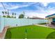 Large backyard featuring a putting green, rock feature, colorful wall mural, and lush landscaping at 3038 E Avalon Dr, Phoenix, AZ 85016