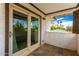 Well-maintained balcony with sliding glass doors showcasing palm trees, tile floors, and white siding at 3038 E Avalon Dr, Phoenix, AZ 85016