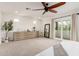 Bright bedroom with a ceiling fan, large dresser, a decorative mirror and sliding doors to a balcony at 3038 E Avalon Dr, Phoenix, AZ 85016