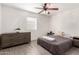 Cozy bedroom with a comfortable bed, wood-look floors, dresser and a ceiling fan at 3038 E Avalon Dr, Phoenix, AZ 85016