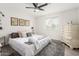 Bright bedroom with a ceiling fan, plush carpeting and a comfortable bed with decorative pillows at 3038 E Avalon Dr, Phoenix, AZ 85016