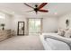 Bright, spacious bedroom featuring a ceiling fan, dresser, and a sliding glass door to the outside at 3038 E Avalon Dr, Phoenix, AZ 85016