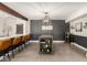 Contemporary dining area features a stylish island, wainscoting, and modern lighting fixture at 3038 E Avalon Dr, Phoenix, AZ 85016