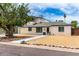 Charming two-story home featuring tidy desert landscaping, a balcony, and white brick exterior at 3038 E Avalon Dr, Phoenix, AZ 85016