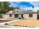 Charming two-story home featuring tidy desert landscaping, a balcony, and white brick exterior at 3038 E Avalon Dr, Phoenix, AZ 85016